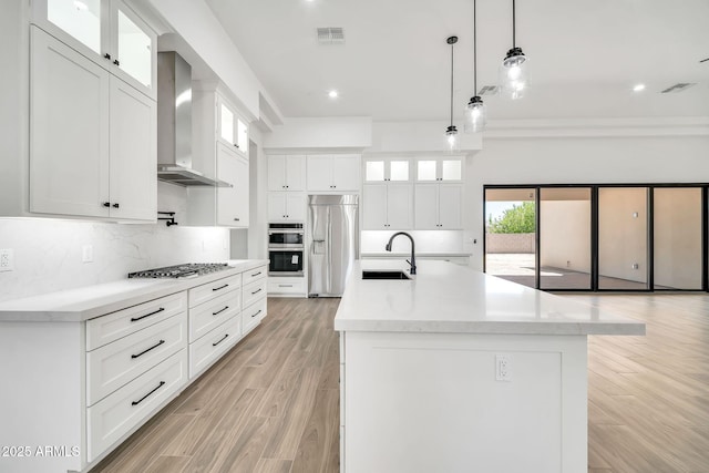 18225 W San Juan Ct, Litchfield Park, AZ 85340 - kitchen with built in refrigerator, wall chimney range hood, a sink, gas cooktop, and tasteful backsplash