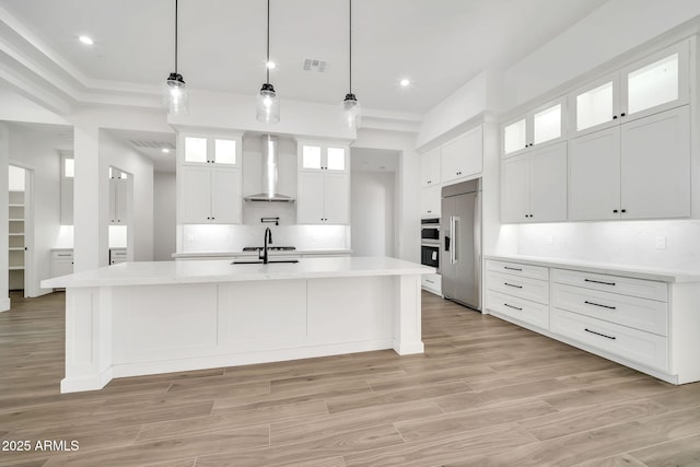18225 W San Juan Ct, Litchfield Park, AZ 85340 - kitchen with wall chimney range hood, built in fridge, backsplash, light countertops, and recessed lighting
