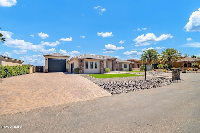 18225 W San Juan Ct, Litchfield Park, AZ 85340 - view of front of property featuring decorative driveway, stone siding, and stucco siding