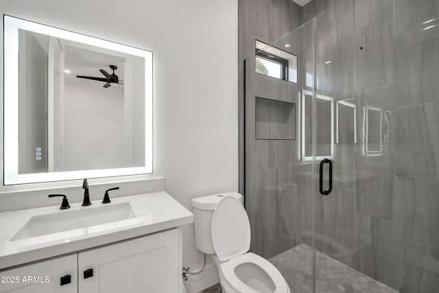 18225 W San Juan Ct, Litchfield Park, AZ 85340 - full bathroom featuring a stall shower, ceiling fan, toilet, and vanity