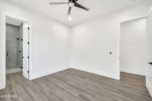 18225 W San Juan Ct, Litchfield Park, AZ 85340 - unfurnished bedroom featuring wood finished floors, baseboards, ceiling fan, and ensuite bath