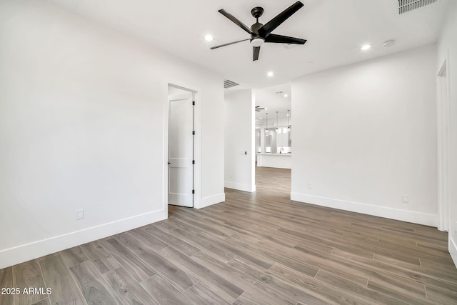 18225 W San Juan Ct, Litchfield Park, AZ 85340 - empty room with ceiling fan, wood finished floors, baseboards, recessed lighting, and a smoke detector