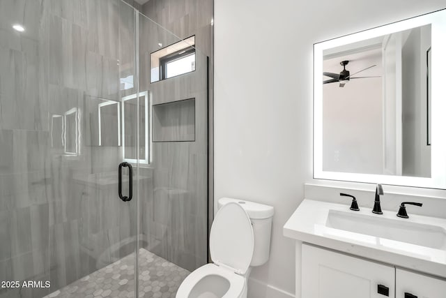 18225 W San Juan Ct, Litchfield Park, AZ 85340 - bathroom with a stall shower, toilet, a ceiling fan, and vanity