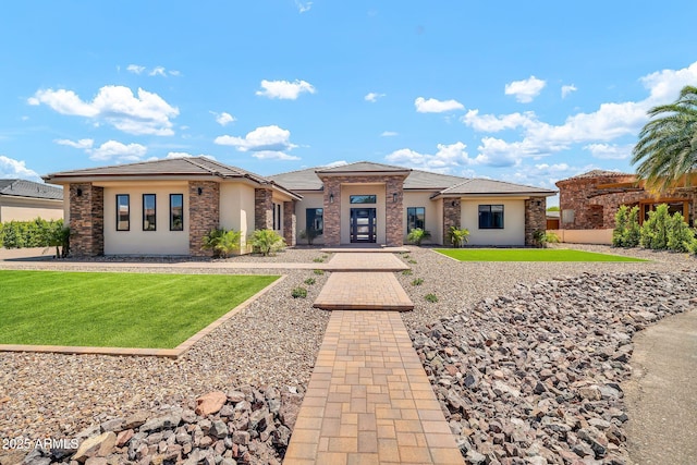 18225 W San Juan Ct, Litchfield Park, AZ 85340 - view of front of home with stone siding, a front lawn, stucco siding, and a tile roof