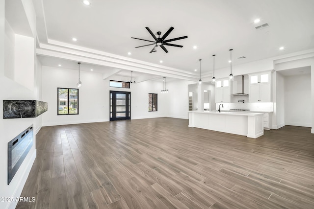 18225 W San Juan Ct, Litchfield Park, AZ 85340 - unfurnished living room with recessed lighting, healthy amount of natural light, a sink, and wood finished floors