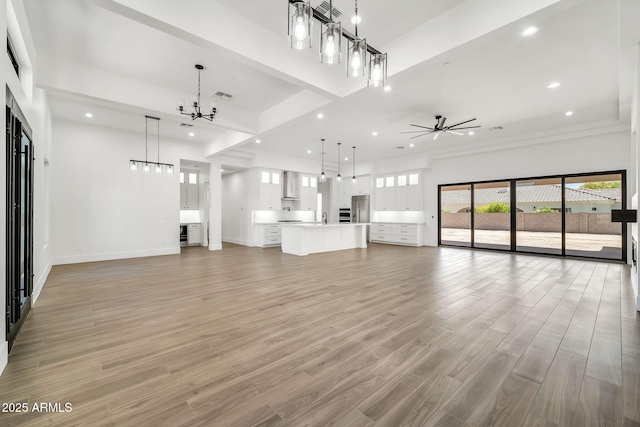 18225 W San Juan Ct, Litchfield Park, AZ 85340 - unfurnished living room with a chandelier, recessed lighting, light wood finished floors, ceiling fan, and baseboards