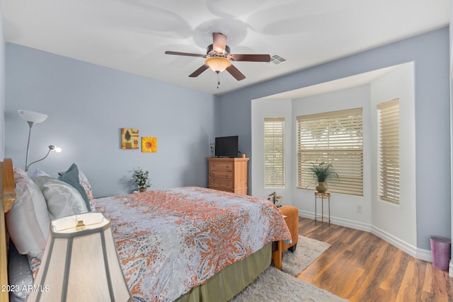 bedroom with hardwood / wood-style flooring and ceiling fan