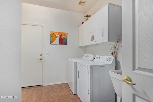 laundry room with cabinets, independent washer and dryer, and sink