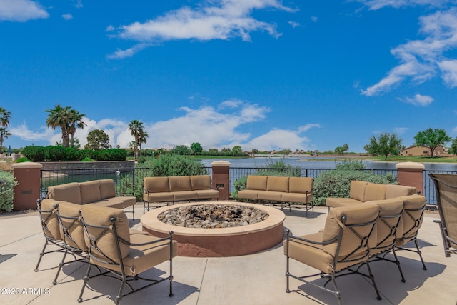 view of patio / terrace with a water view and an outdoor living space with a fire pit