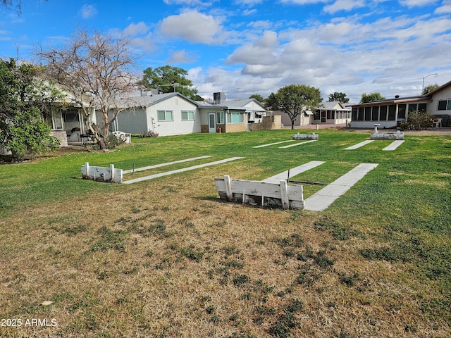 view of yard featuring a sunroom