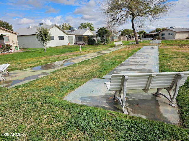 view of yard featuring a residential view and shuffleboard