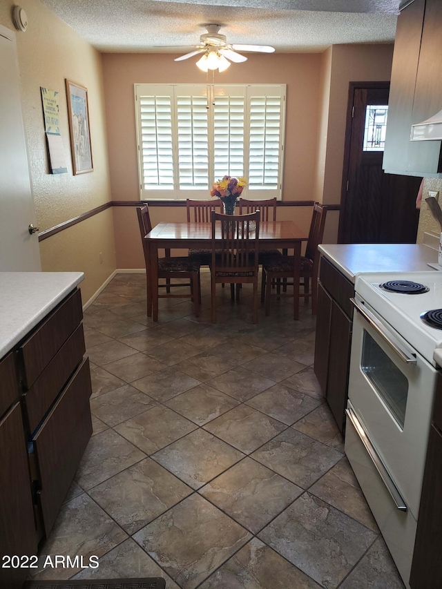 dining room with a textured ceiling and a ceiling fan