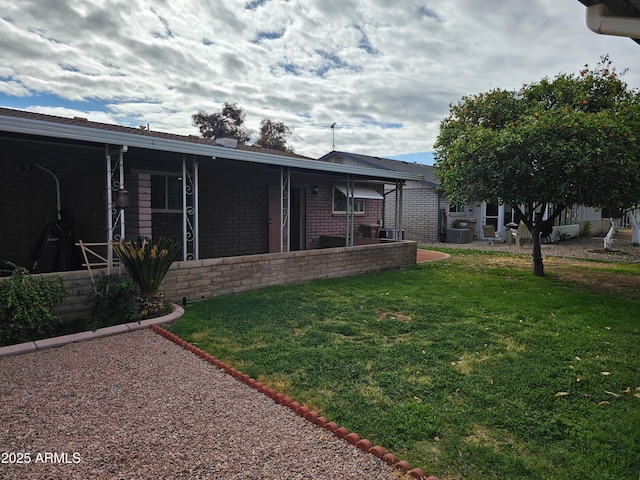 view of yard featuring a patio and central AC unit