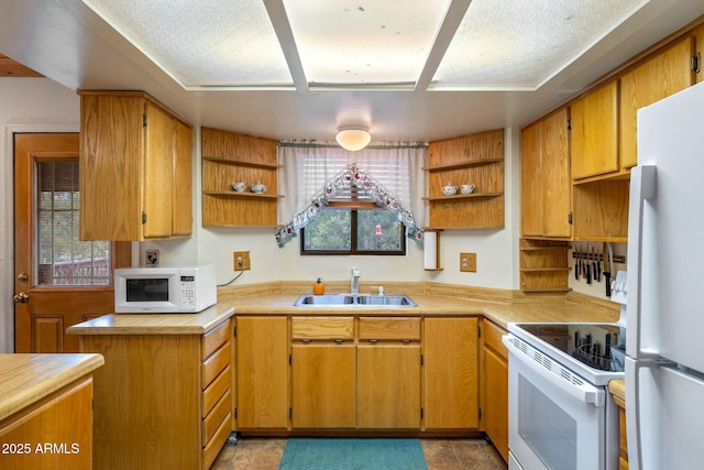 kitchen featuring white appliances, sink, and a wealth of natural light