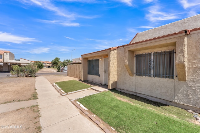 4836 W Rose Ln, Glendale, AZ 85301 - view of side of home featuring a tile roof and stucco siding