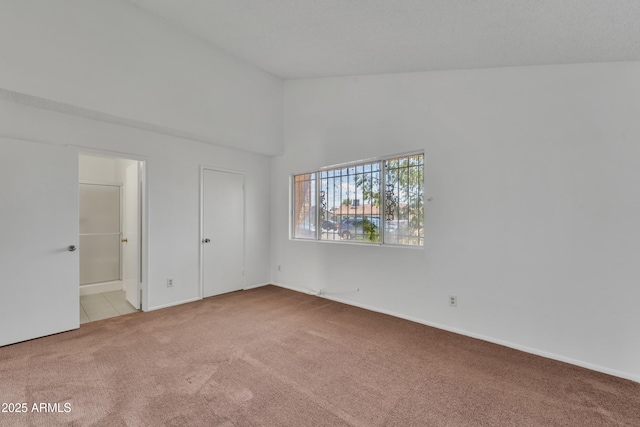 4836 W Rose Ln, Glendale, AZ 85301 - unfurnished bedroom with baseboards, carpet, connected bathroom, and high vaulted ceiling