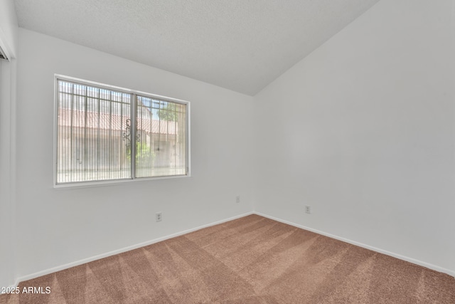4836 W Rose Ln, Glendale, AZ 85301 - unfurnished room featuring baseboards, vaulted ceiling, carpet flooring, and a textured ceiling