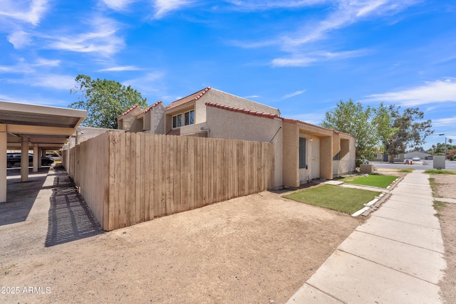 4836 W Rose Ln, Glendale, AZ 85301 - view of property exterior featuring fence, a tile roof, and stucco siding