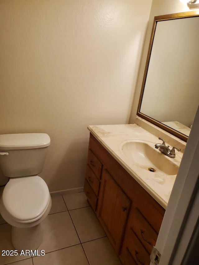 bathroom with vanity, tile patterned flooring, and toilet