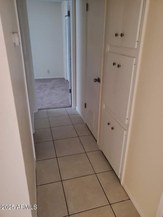 corridor featuring light tile patterned flooring