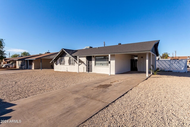 single story home featuring a carport