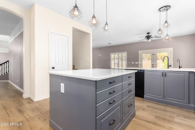 kitchen featuring light wood-type flooring, a center island, and gray cabinetry