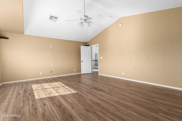 spare room with ceiling fan, vaulted ceiling, and dark hardwood / wood-style floors