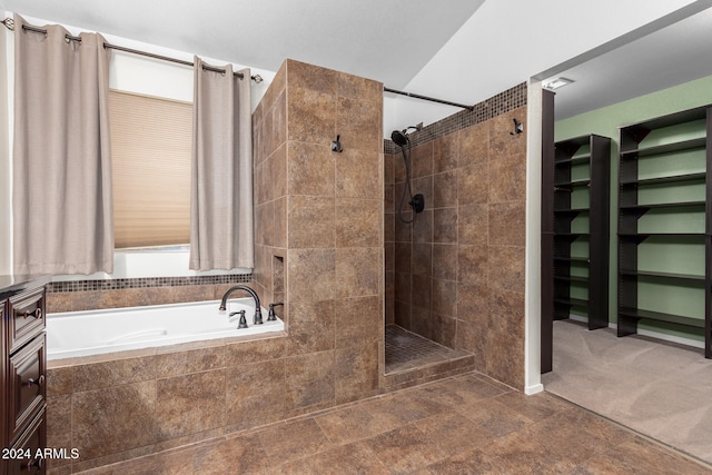 bathroom with vanity, tile patterned floors, and plus walk in shower