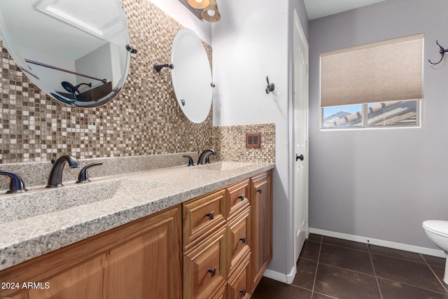 bathroom with toilet, tasteful backsplash, vanity, and tile patterned floors