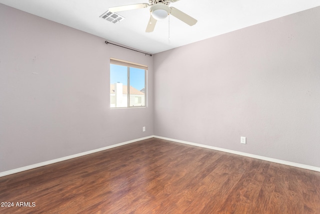 unfurnished room featuring dark wood-type flooring and ceiling fan