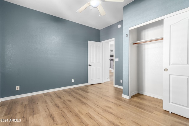 unfurnished bedroom with light hardwood / wood-style flooring, ceiling fan, and a closet