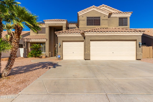 mediterranean / spanish-style home with a garage