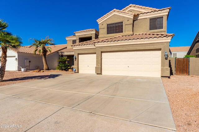 mediterranean / spanish-style home with a garage