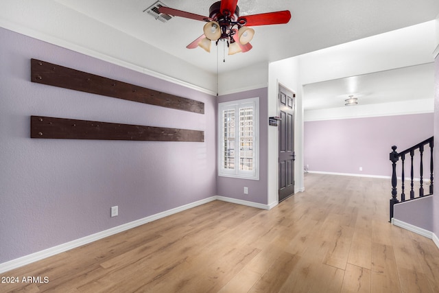 unfurnished room with light wood-type flooring and ceiling fan