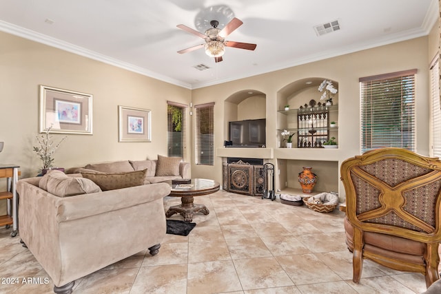 living room with ceiling fan, ornamental molding, light tile patterned flooring, and built in shelves