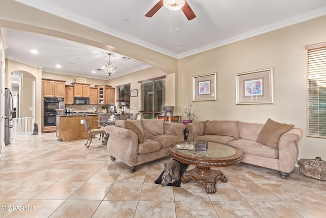 tiled living room featuring ornamental molding and ceiling fan with notable chandelier