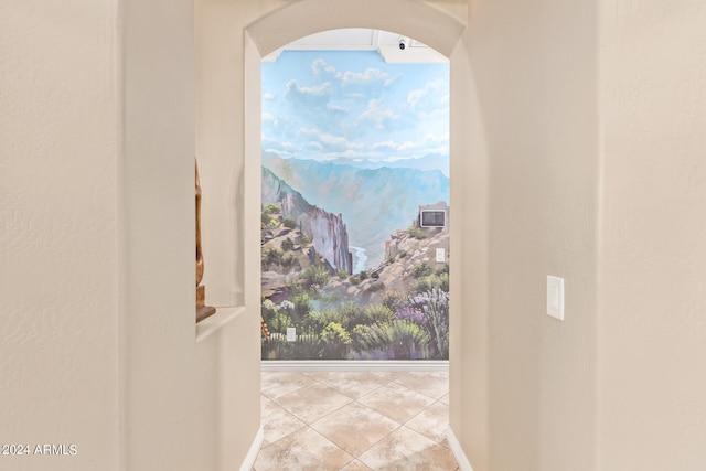 doorway to outside with light tile patterned flooring and a mountain view