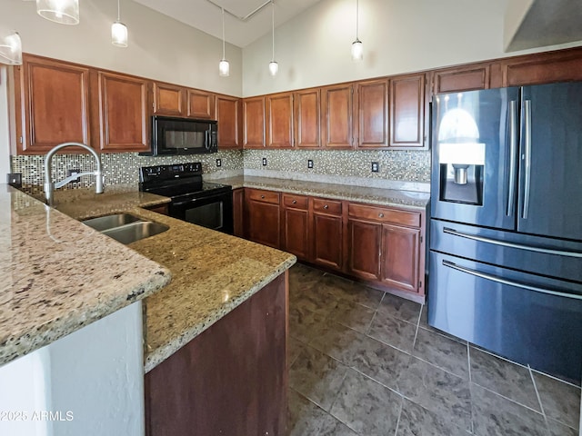 kitchen featuring a sink, tasteful backsplash, black appliances, and light stone counters