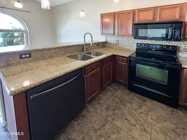 kitchen featuring a peninsula, a sink, light stone counters, black appliances, and backsplash