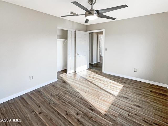 unfurnished bedroom with baseboards, a closet, wood finished floors, and a ceiling fan