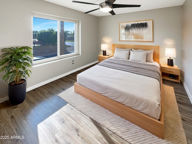 bedroom with baseboards, ceiling fan, and wood finished floors