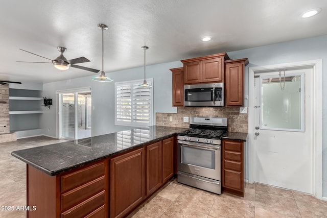 kitchen with kitchen peninsula, backsplash, stainless steel appliances, ceiling fan, and dark stone countertops