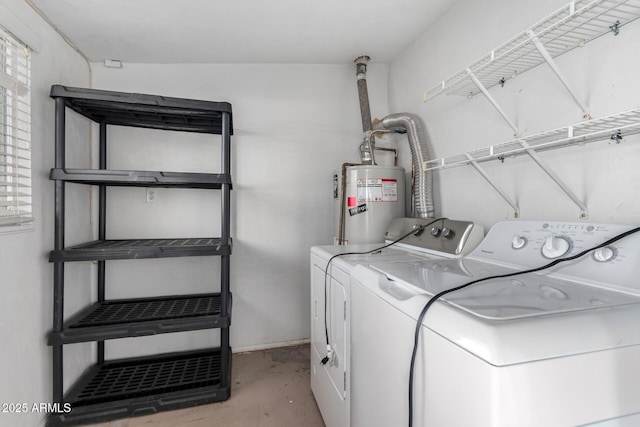 laundry area with washing machine and clothes dryer and gas water heater