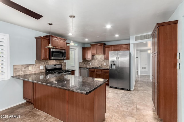 kitchen featuring kitchen peninsula, hanging light fixtures, stainless steel appliances, and sink