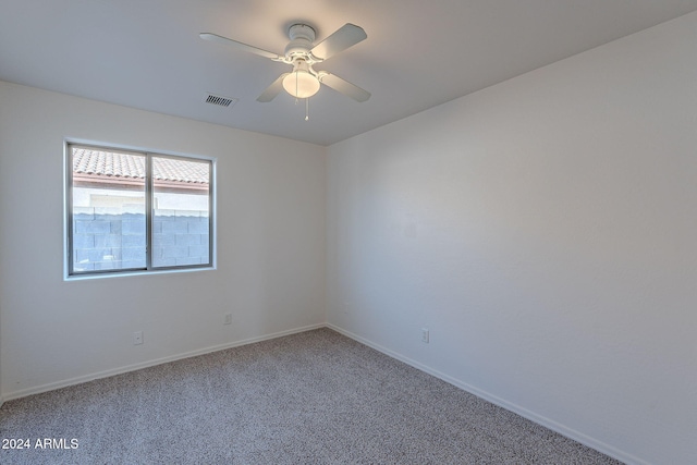 unfurnished room featuring ceiling fan and carpet floors