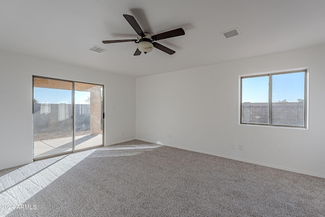 carpeted empty room featuring ceiling fan