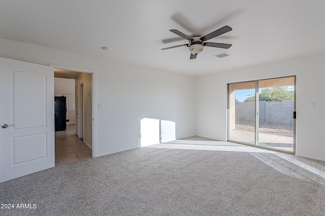 carpeted spare room with ceiling fan