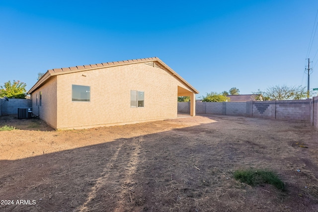 back of house with central AC