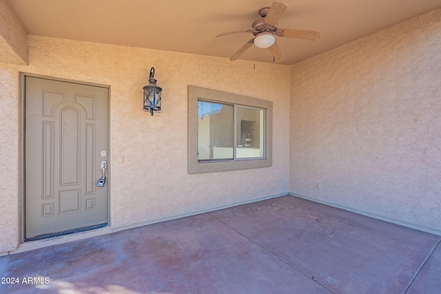 property entrance with ceiling fan and a patio