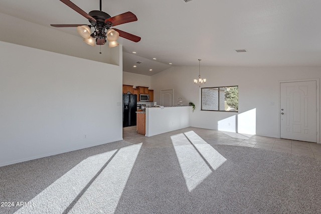 unfurnished living room featuring vaulted ceiling, light carpet, and ceiling fan with notable chandelier